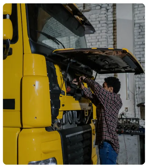 man repairing a dump truck